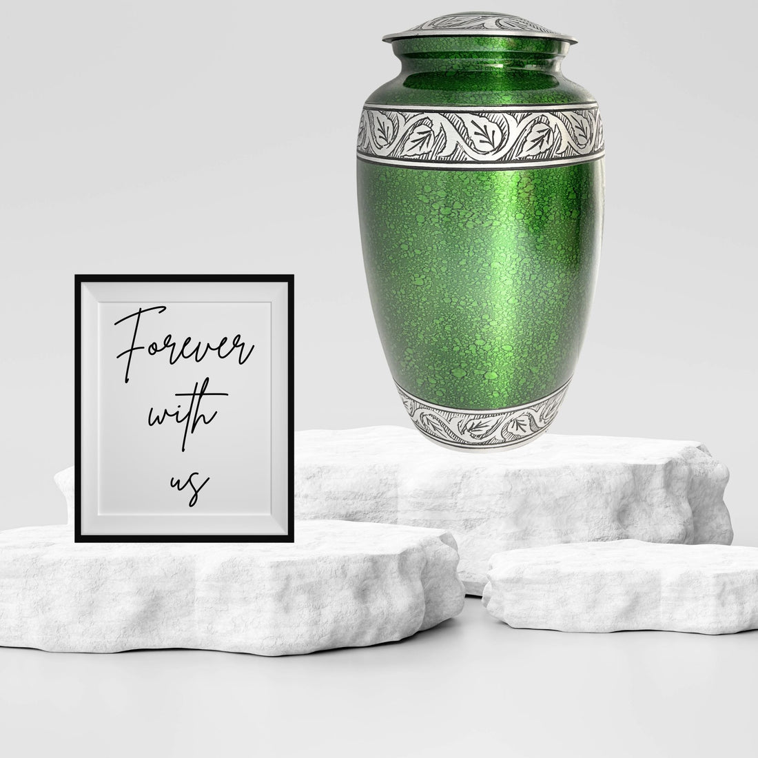 Green metallic urn with silver leaf patterns on a white background