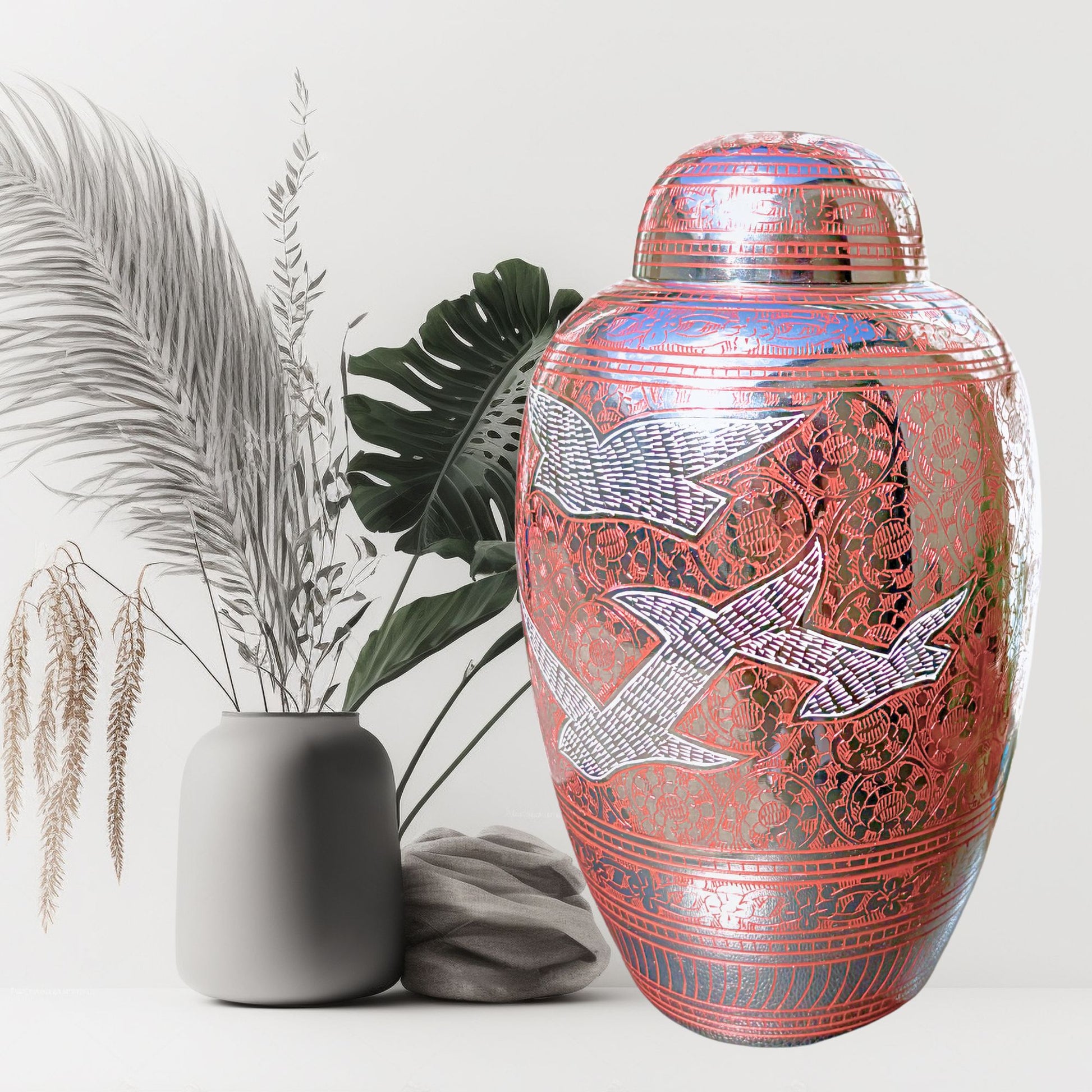 Decorative urn with bird designs on a white background