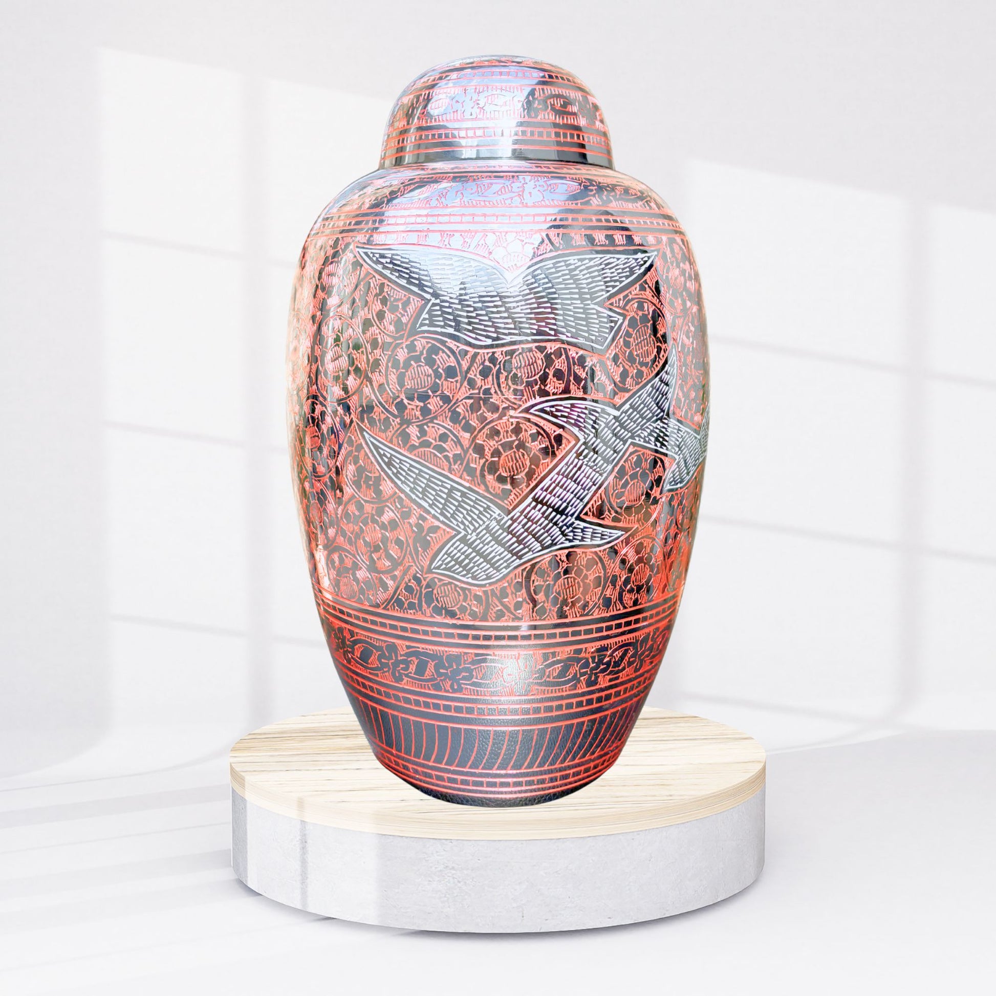 Decorative urn with bird designs on a white background