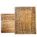 Two wooden panels with intricate carvings on a white background