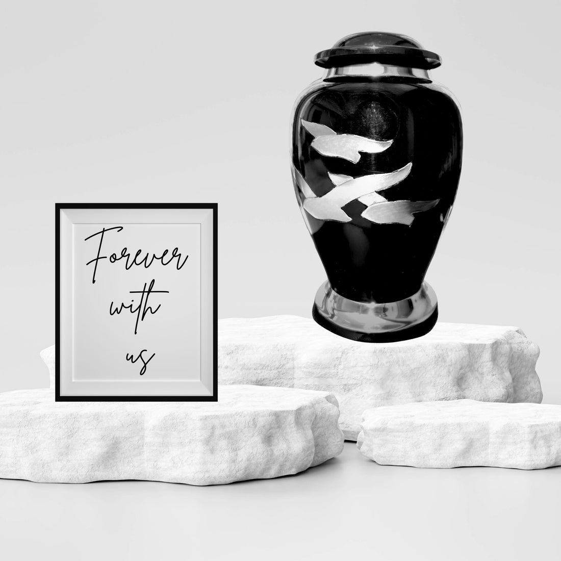 Black urn with silver butterfly designs on a white background