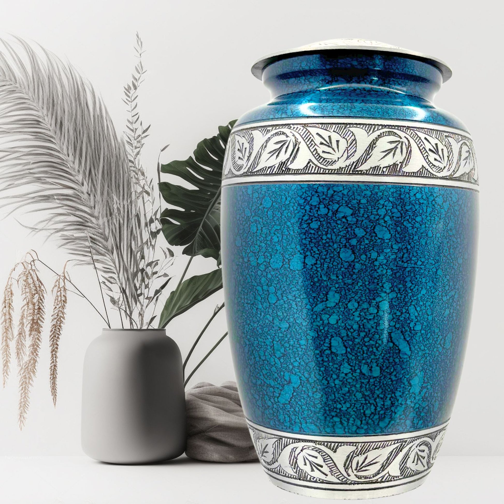 Blue ceramic urn with decorative patterns on a white background