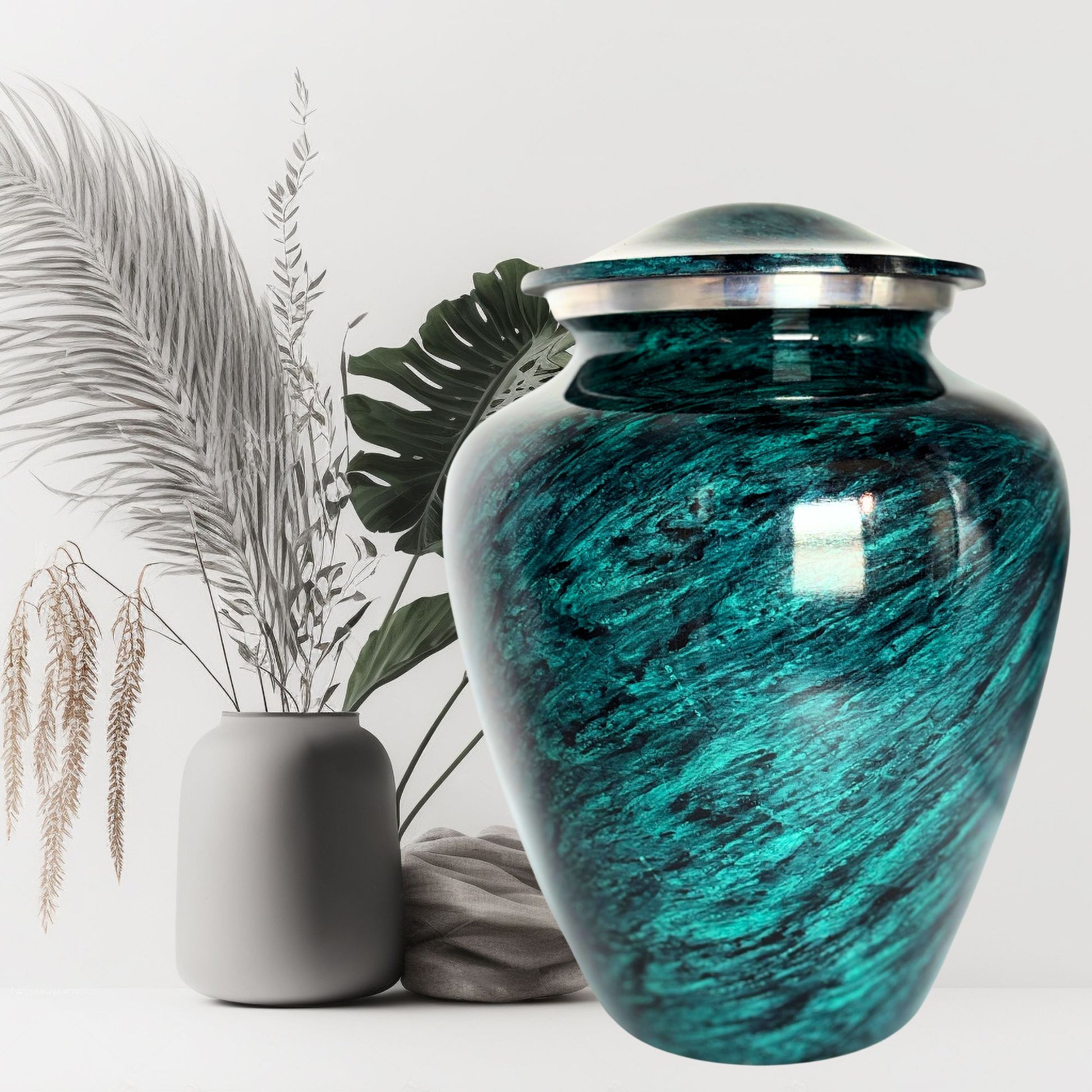Teal urn with silver lid on a white background