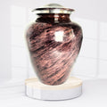 Copper urn with a silver lid on a white background