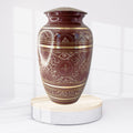 Decorative urn with intricate patterns on a white background
