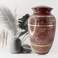 Decorative urn with intricate patterns on a white background