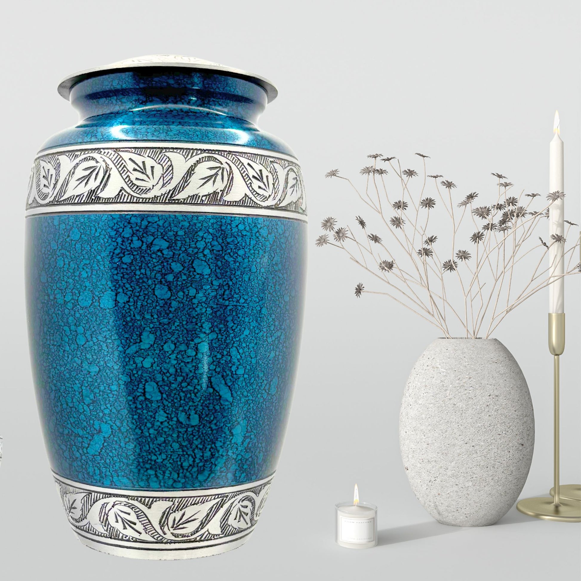Blue ceramic urn with decorative patterns on a gray background