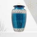 Blue ceramic urn with silver decorative band on a white background
