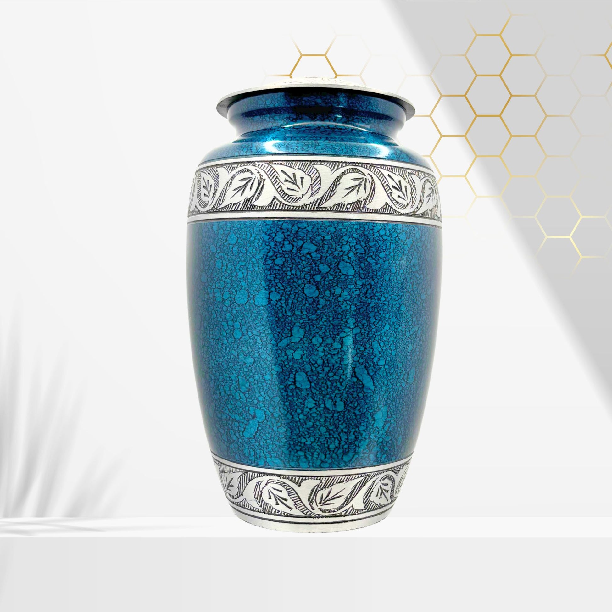 Blue ceramic urn with silver decorative band on a white background
