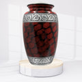 Red and black patterned urn on a white background