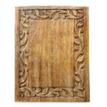 Wooden panel with intricate carvings on a white background