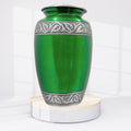 Green urn with silver decorative band on a white background