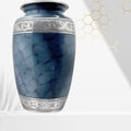 Blue marble-patterned urn with silver decorative band on a white background