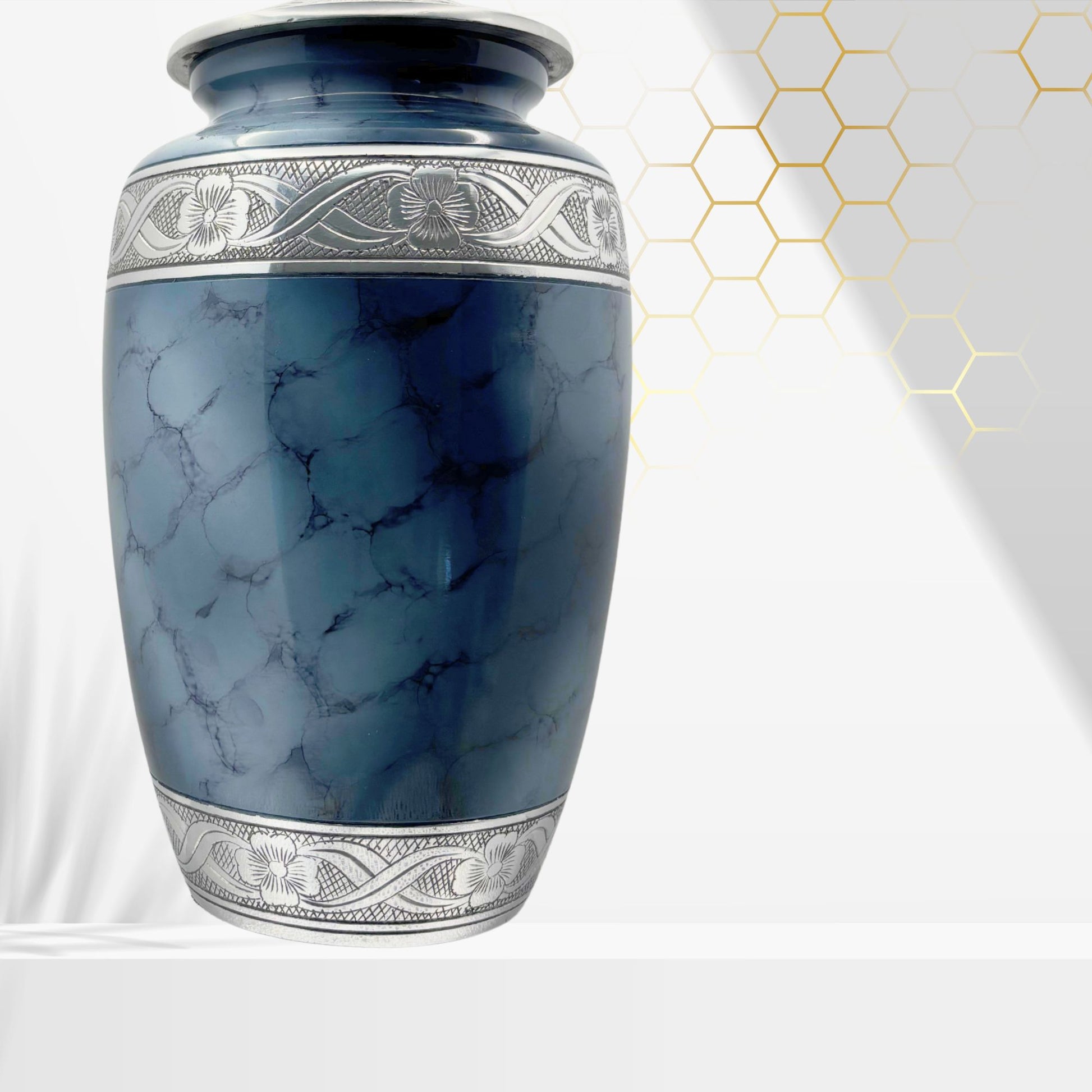 Blue marble-patterned urn with silver decorative band on a white background