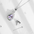 Silver necklace with a teardrop-shaped crystal pendant on a white background