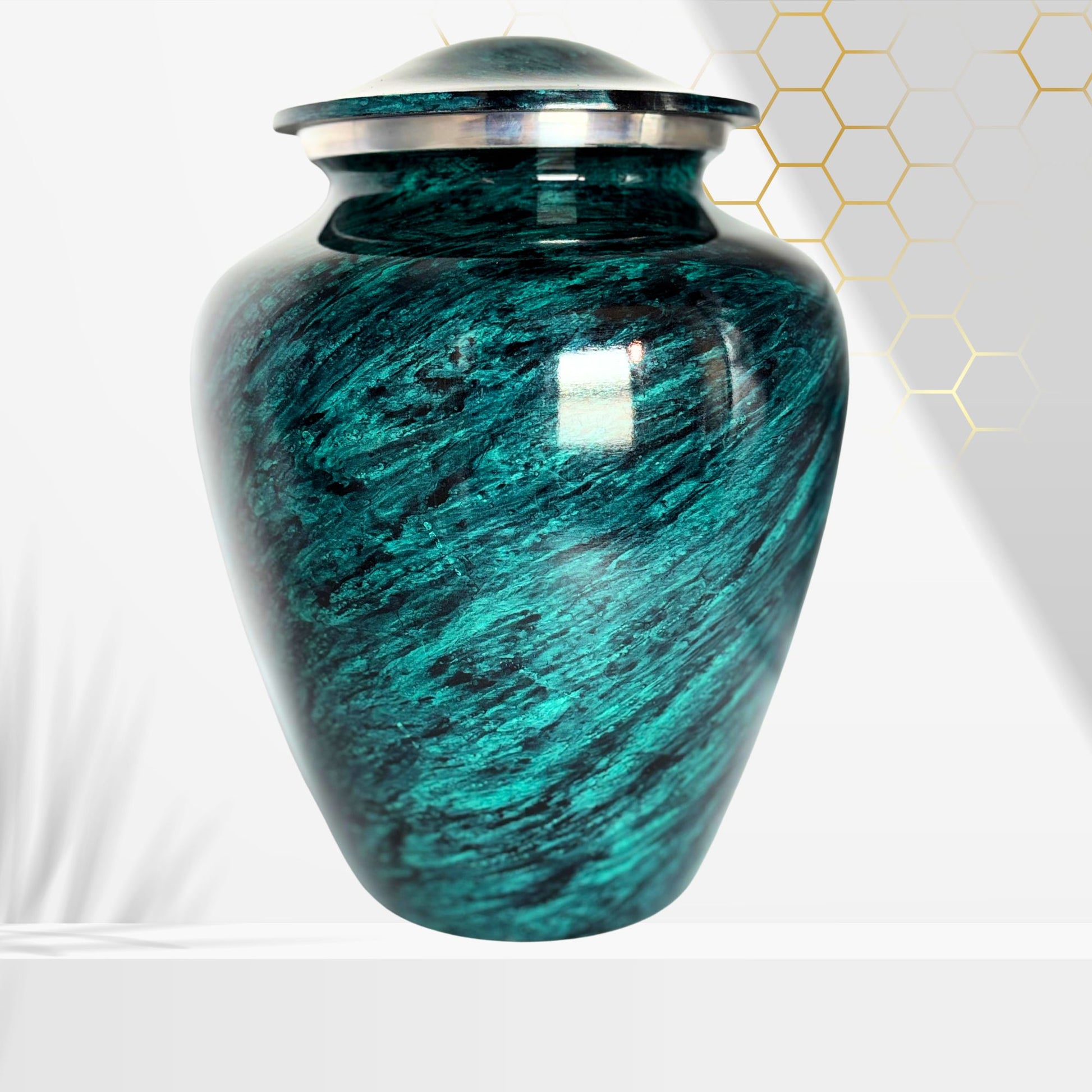 Teal marbled urn with silver lid on a white background