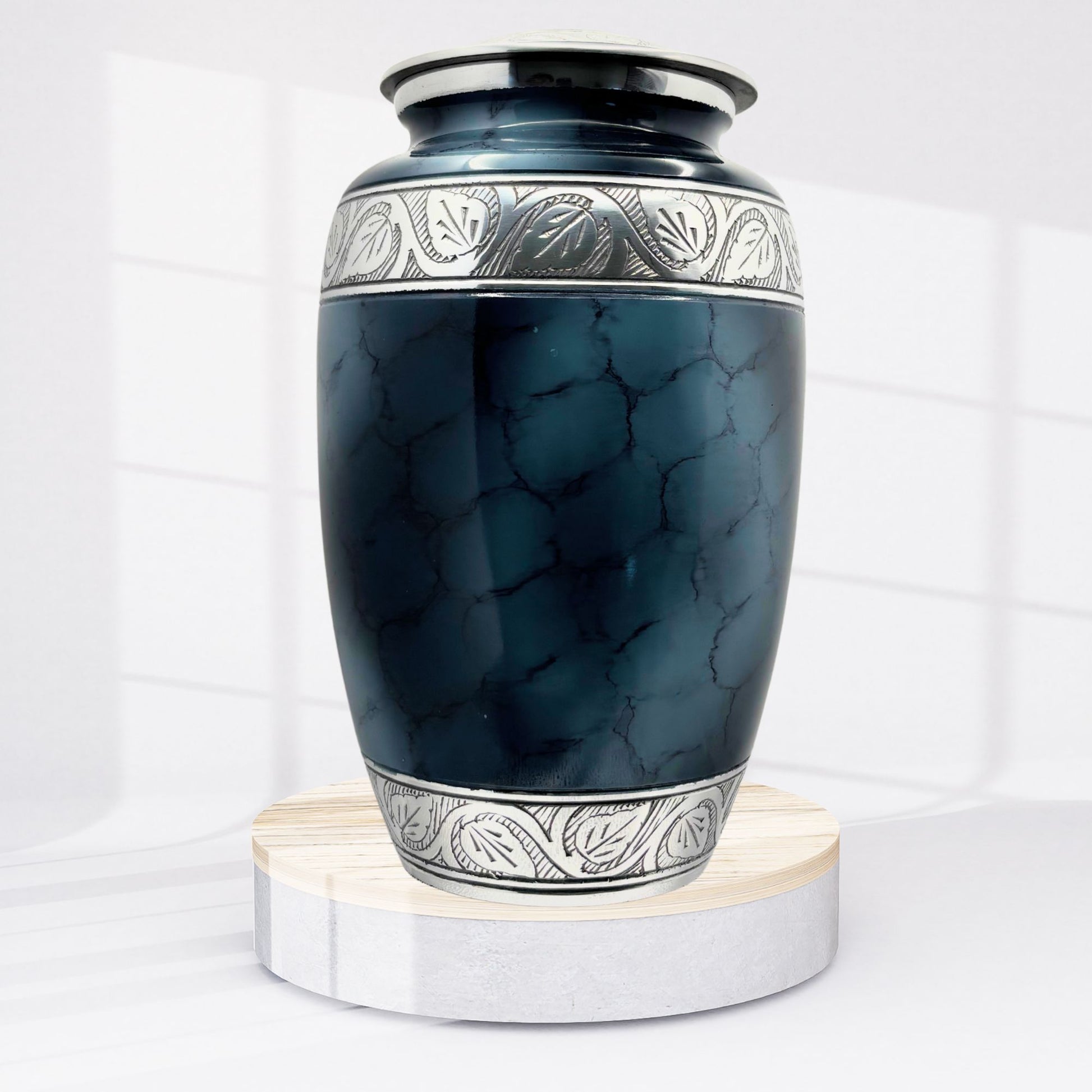 Blue marble-patterned urn with silver decorative band on a white background