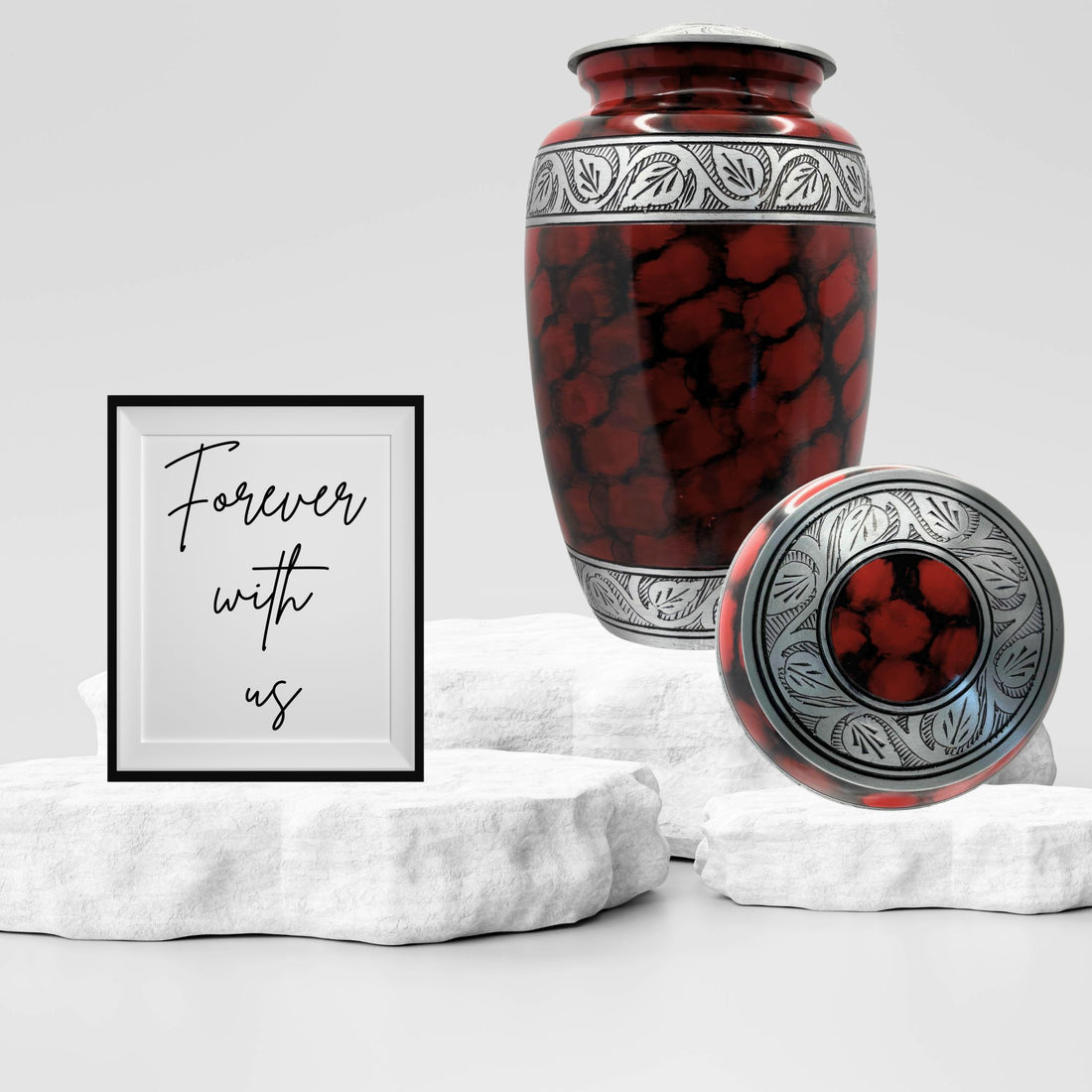 Red and black patterned urn with silver decorative band on a white background