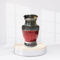 Red urn with silver top on a white background