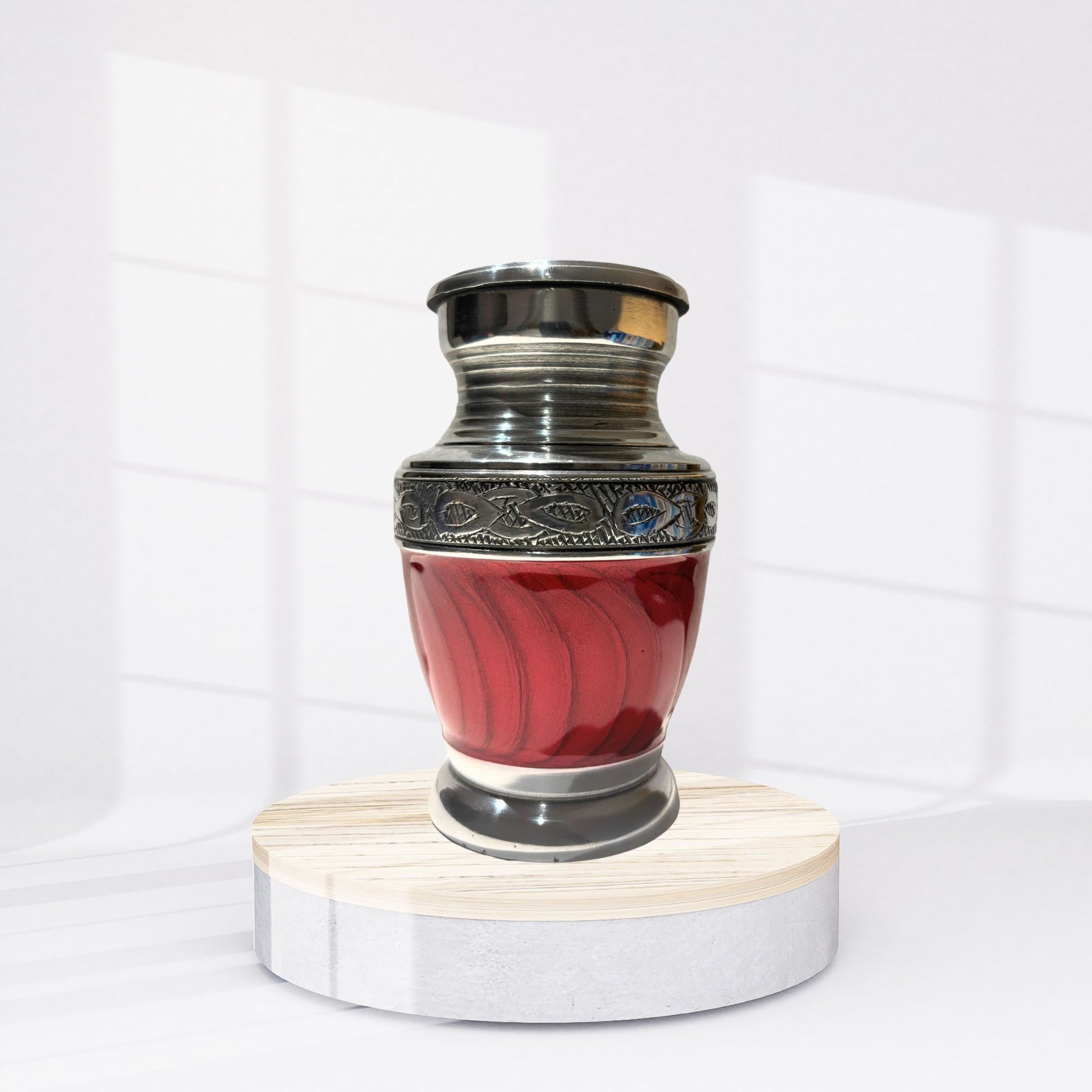 Red urn with silver top on a white background