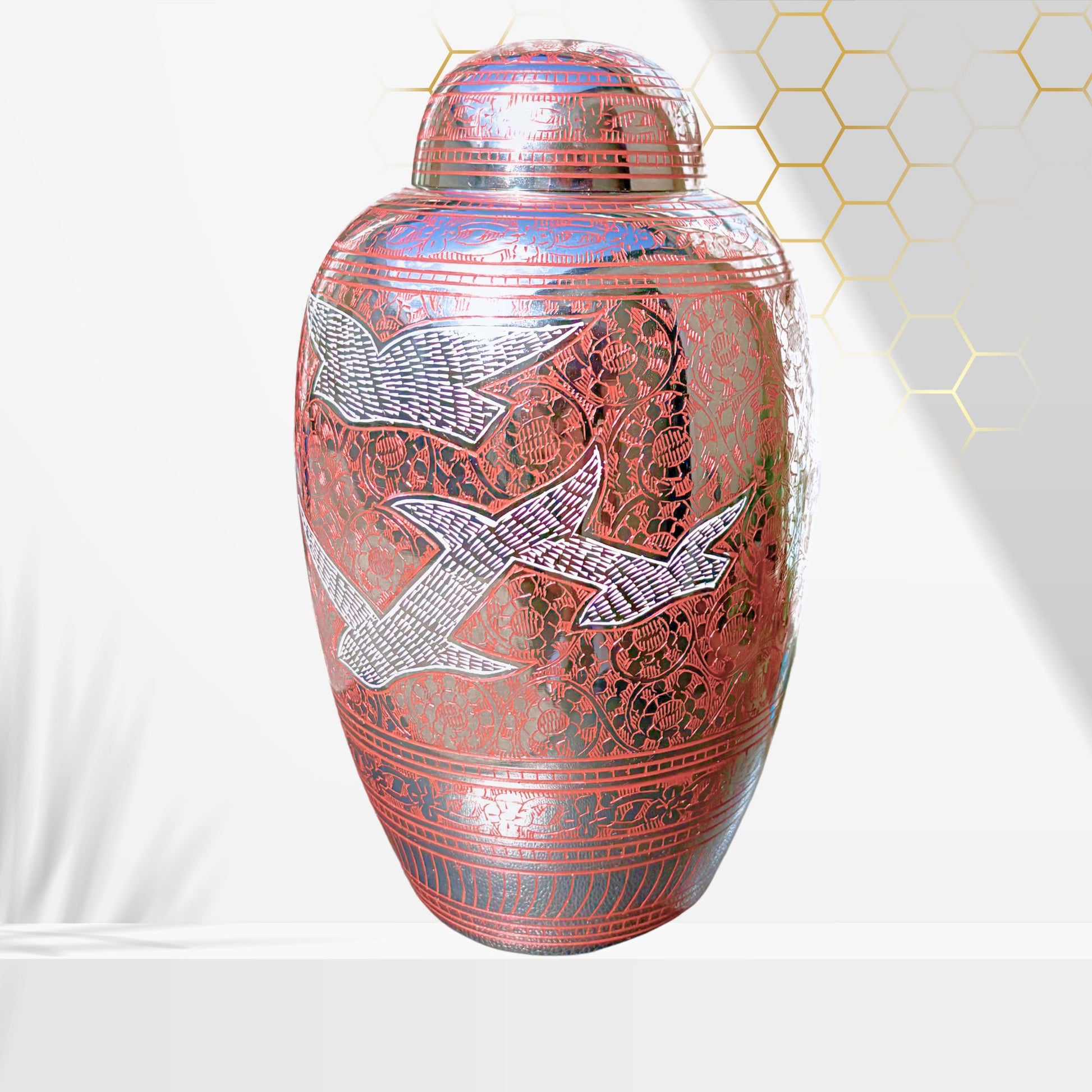 Decorative urn with intricate designs on a white background