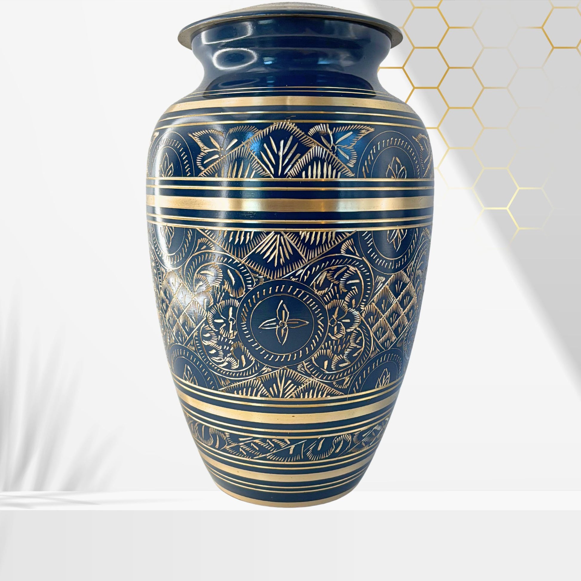 Decorative blue and gold vase with intricate patterns on a white background