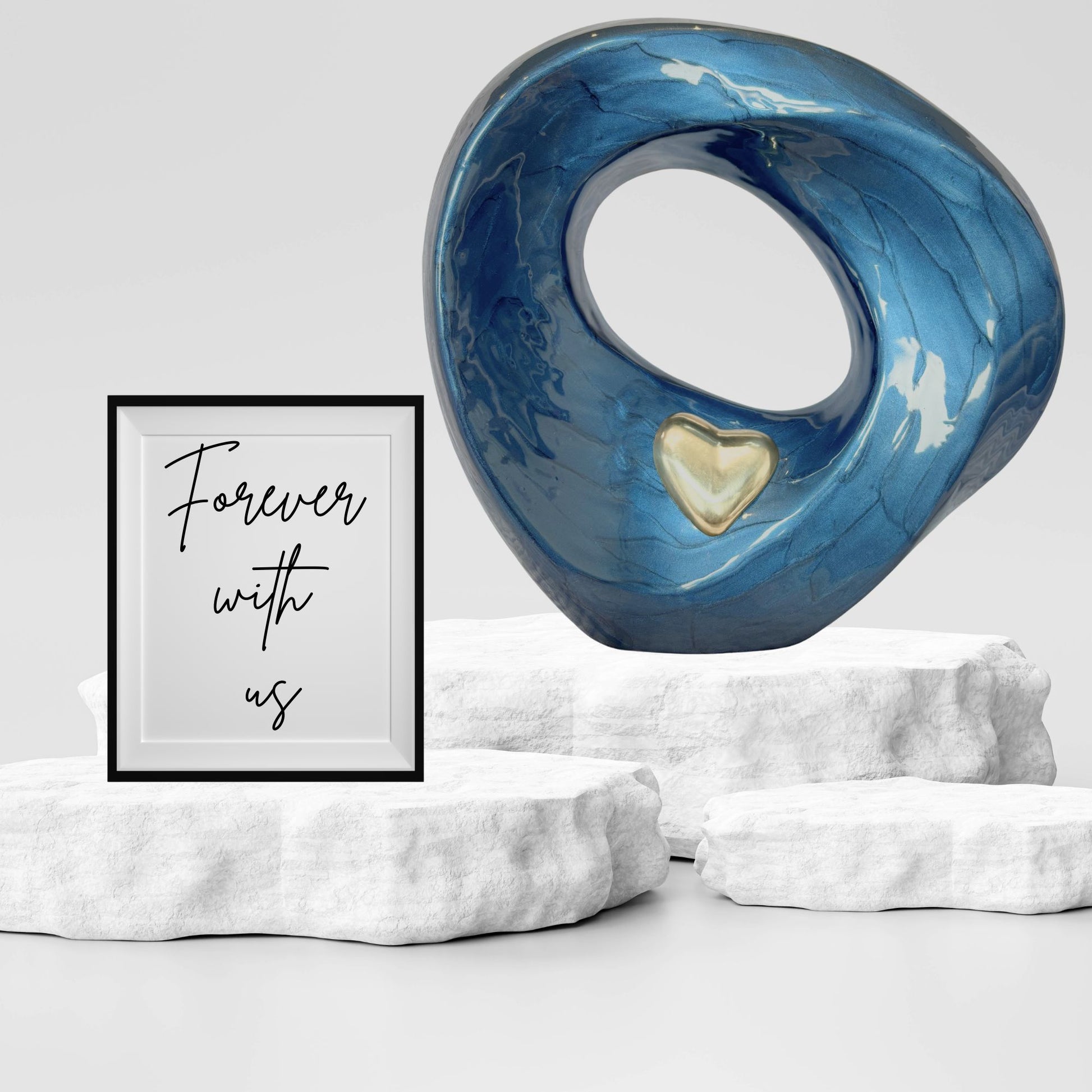 Blue marble-like sculpture with a heart detail on a white pedestal, accompanied by a framed quote 'Forever with us' on a light gray background.