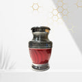 Red urn with silver decorative top on a white background