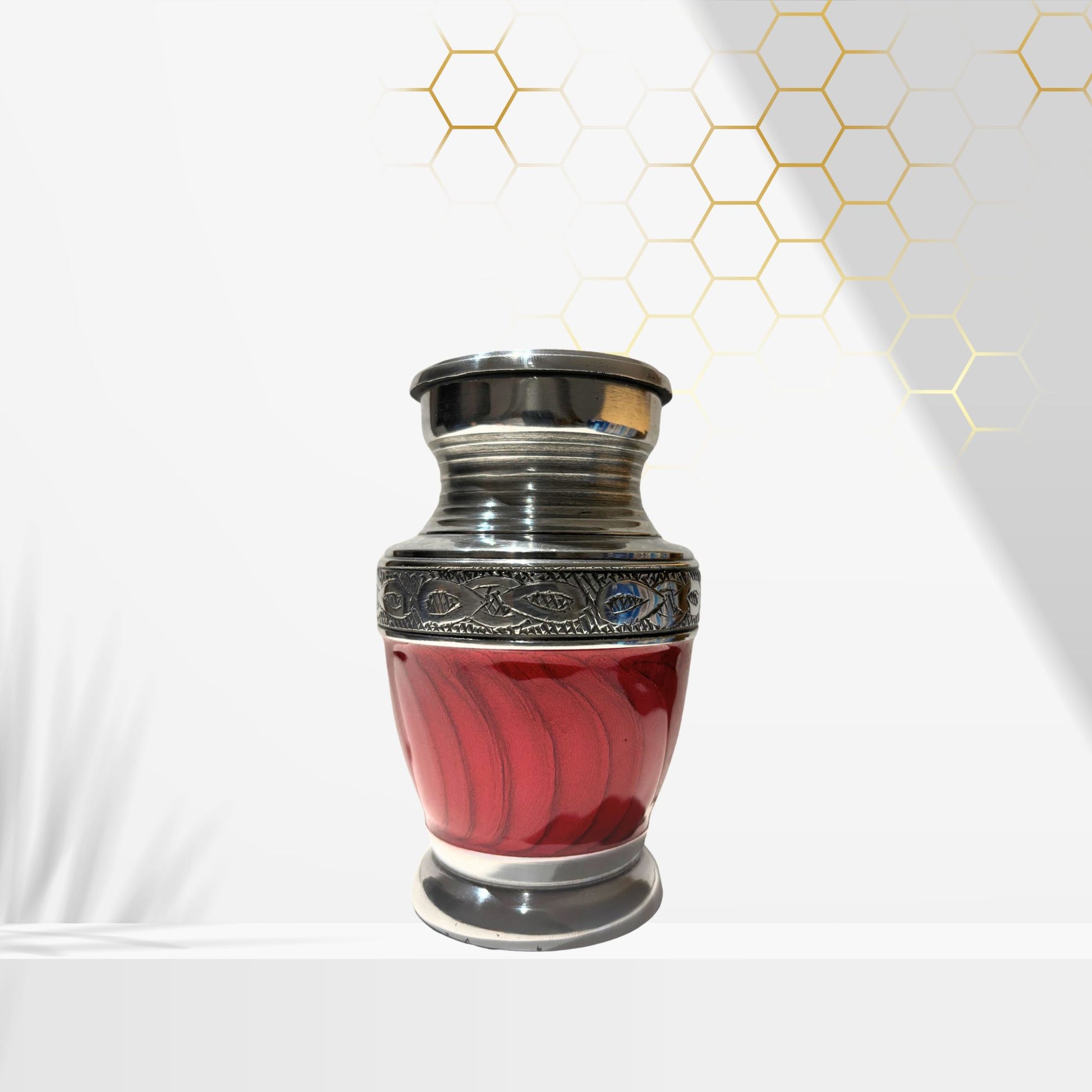 Red urn with silver decorative top on a white background
