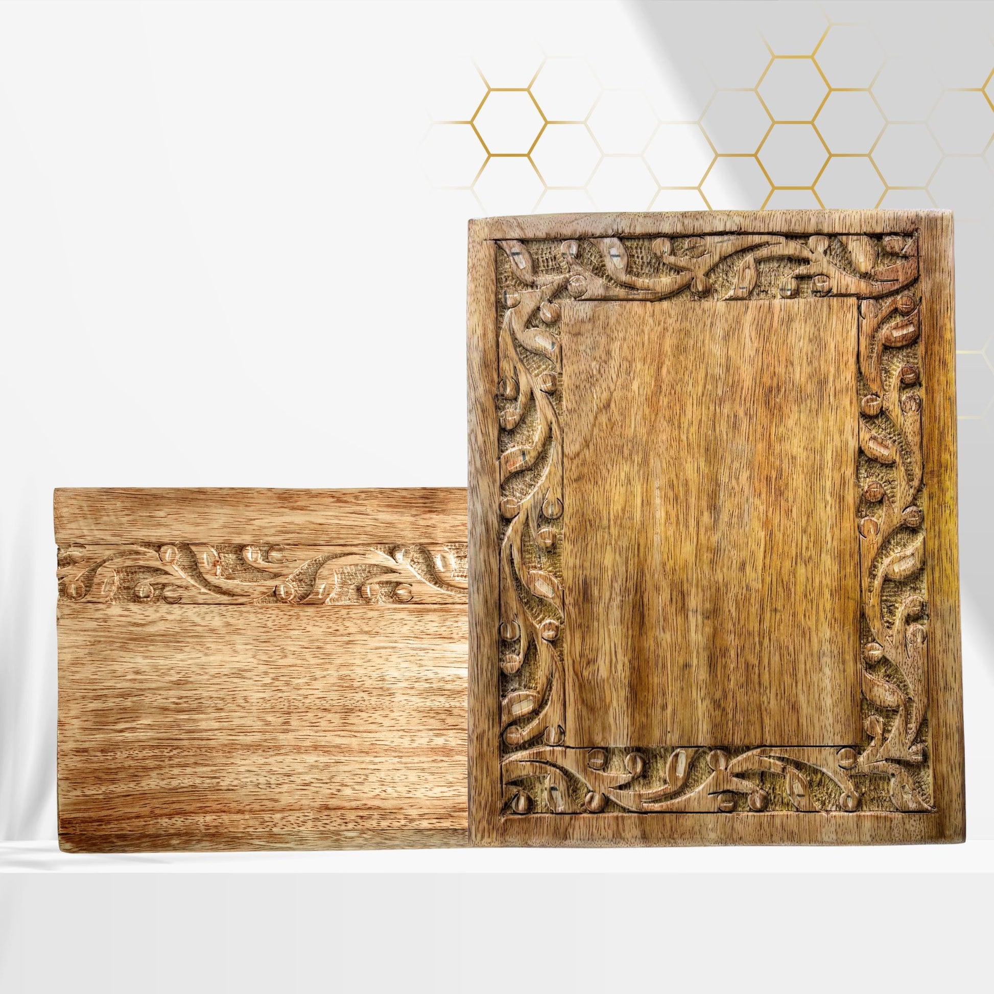 Two wooden cutting boards with intricate carvings on a white background