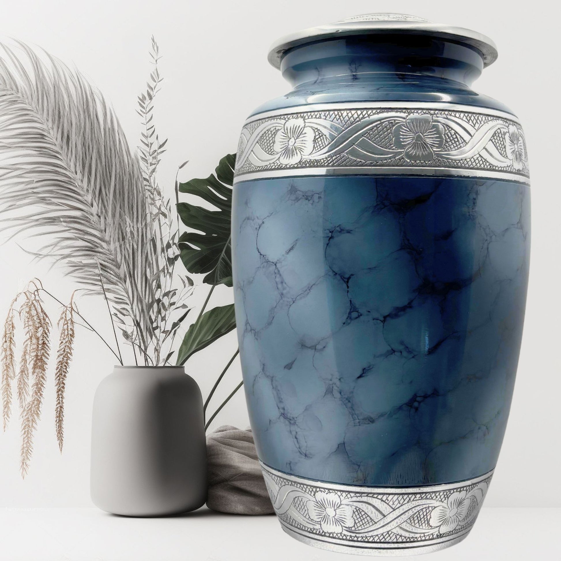 Blue marble-patterned urn with silver detailing on a white background
