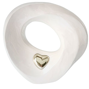 White ceramic ring Urn with a gold heart-shaped inset on a white background