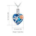 Heart-shaped pendant with blue crystal, silver bird, and peach rose on a white background with measurements and weight details.