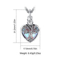Heart-shaped pendant with tree design and measurements on a white background