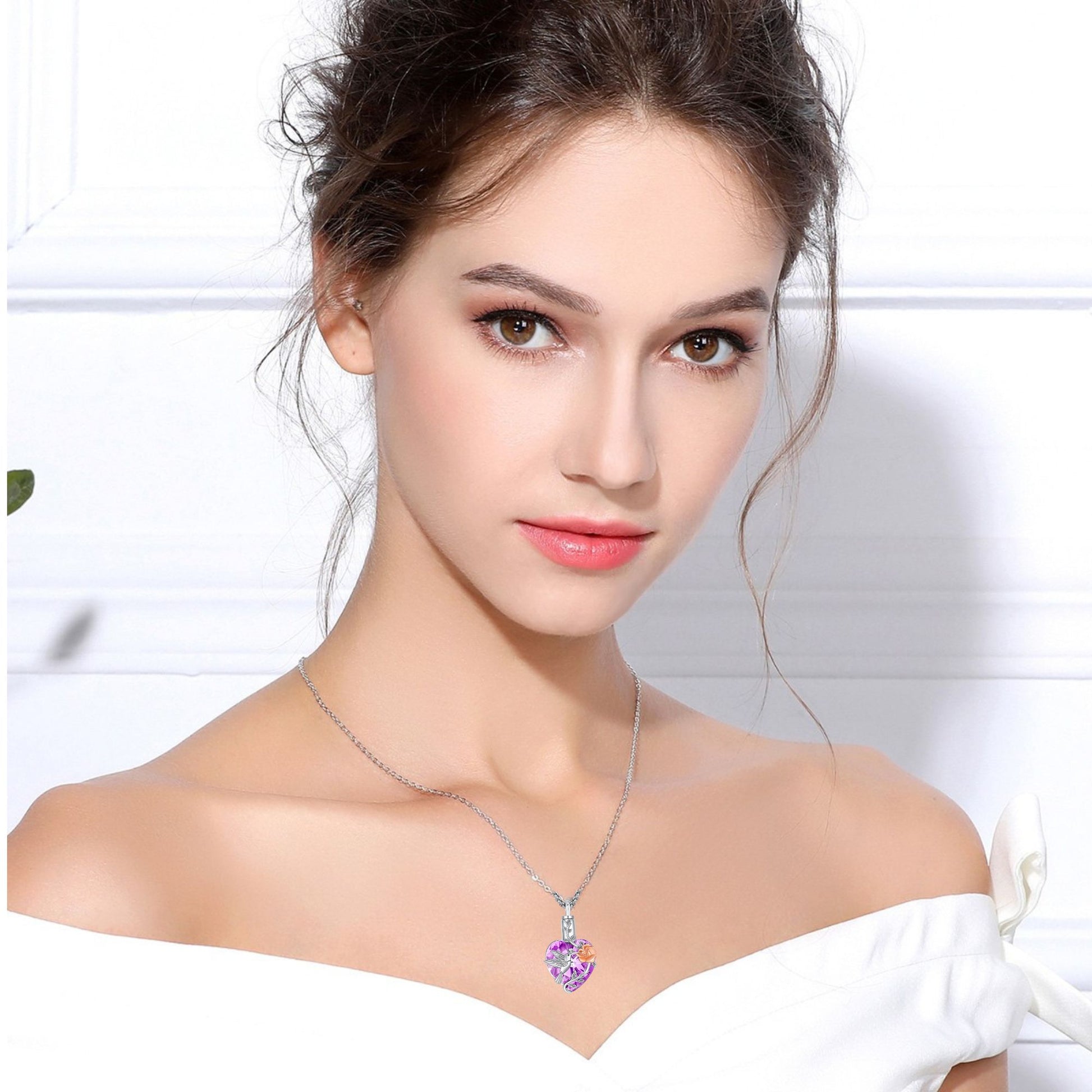 Woman wearing a necklace with a colorful pendant against a white background