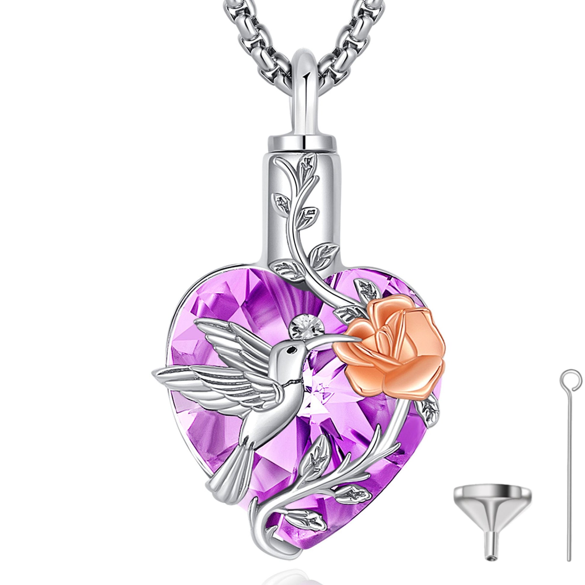 Heart-shaped pendant with a hummingbird, rose, and purple gemstone on a white background