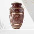 Decorative urn with intricate patterns on a white background