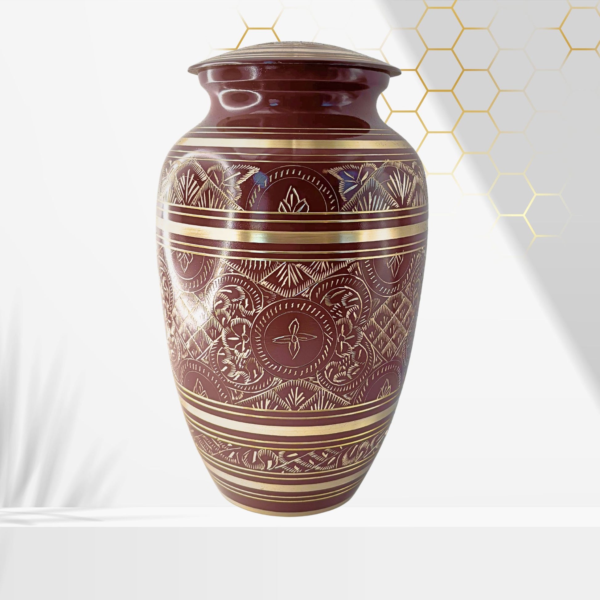 Decorative urn with intricate patterns on a white background
