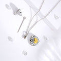 Silver necklace with a yellow pendant on a white background