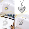 Heart-shaped pendant with paw print design and engraved text on a white background