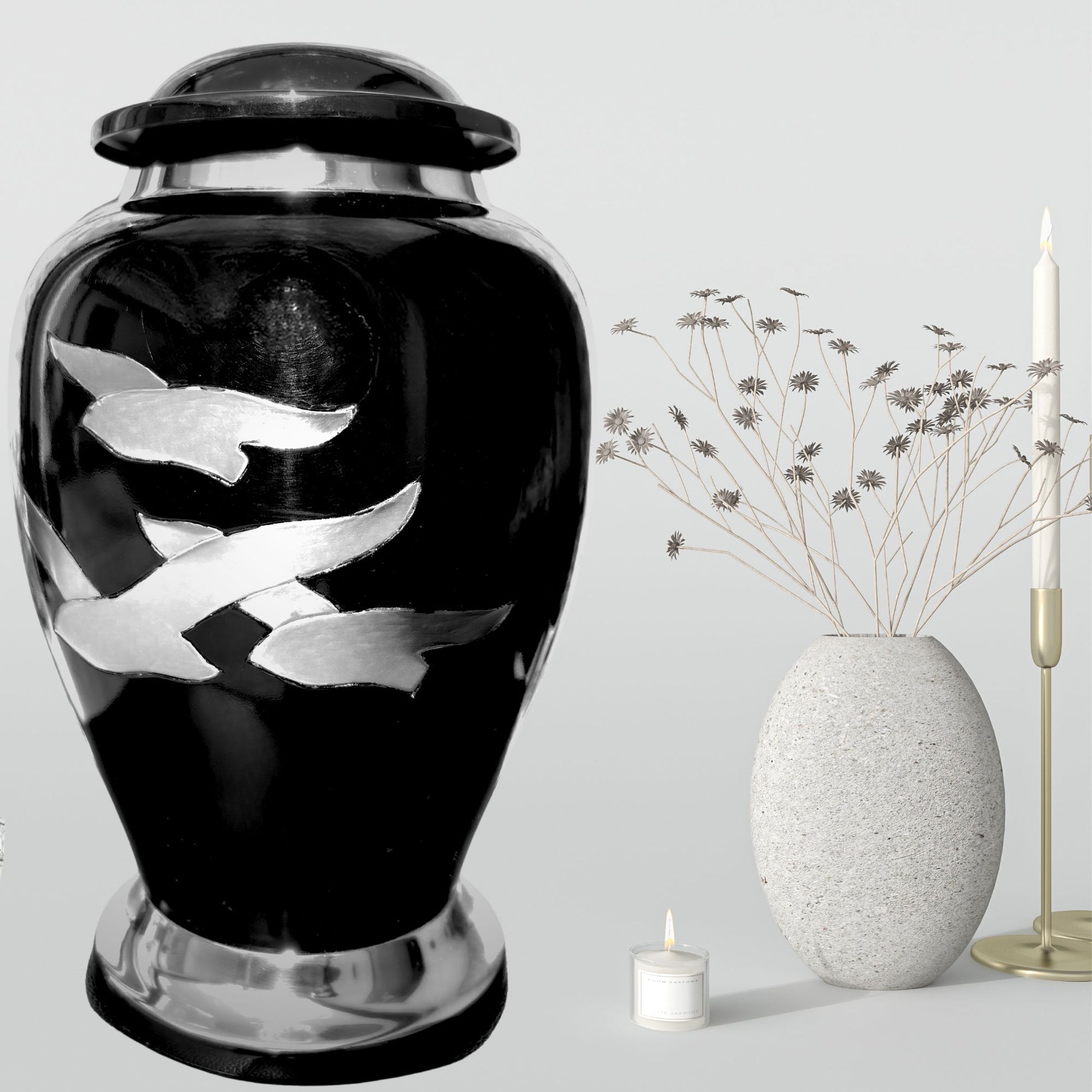 Black urn with silver fish designs on a gray background