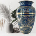 Decorative blue and gold urn with a plain background